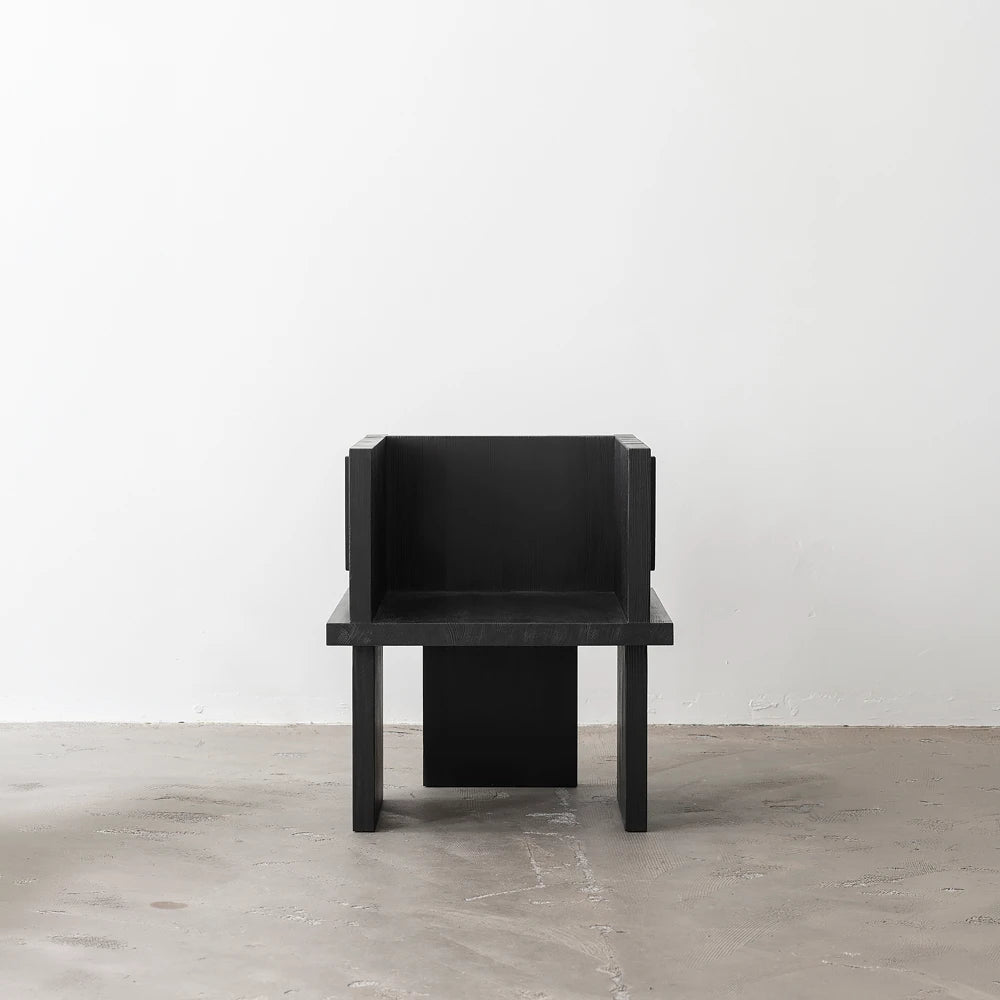 Full front view of the Itooraba Chair Black by Sizar Alexis, emphasizing its compact proportions and burned solid pine structure.
